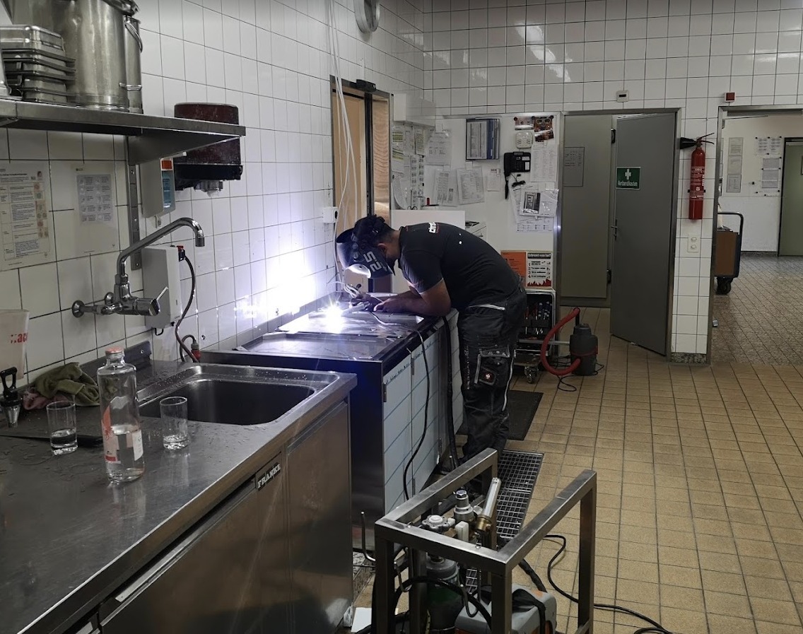 Techniker bei der Reparatur eines Kochgeräts